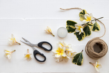 Fototapeta na wymiar herbal honey lemon healthy drinks health care for sore throat and flowers frangipani ,scissors ,rope decorate on background white wooden 