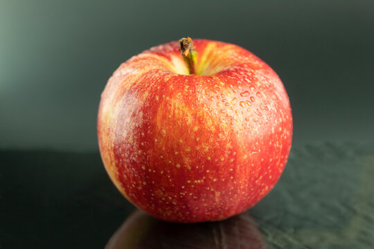Fresh red apple on a dark background