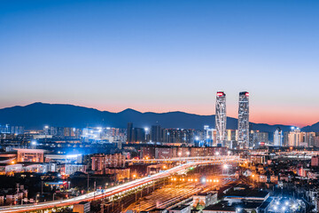 Fototapeta na wymiar Night view of the twin towers, viaduct and railway station in Kunming, Yunnan, China 