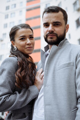 Newly married couple in front of new apartment building.