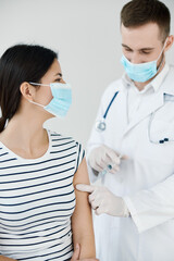 Naklejka premium the doctor injects the vaccine into the patient's shoulder health protection against the virus covid 