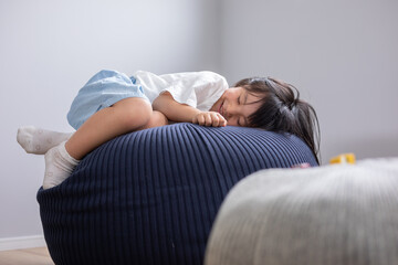 クッションの上にかわいい少女が気持ちよくお昼寝している
