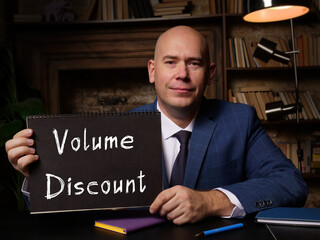 Financial concept meaning Volume Discount with sign on blank card in hand.