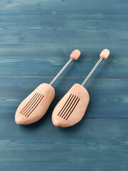 Wooden shoe lasts on a wooden background.