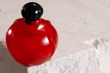 Naklejka na ściany i meble Bottle of perfume on cinder block close up