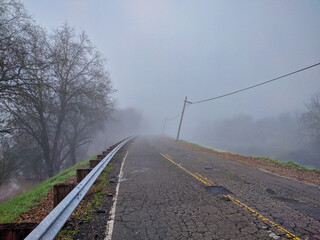 Old levee road on a foggy day in delta region 
