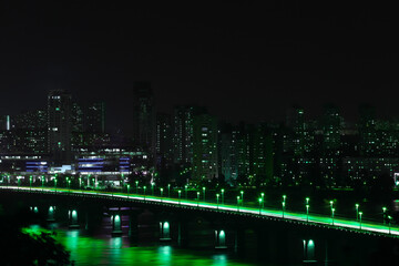 Beautiful view of modern city at night on St. Patrick's Day