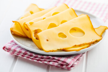 Sliced smoked hard cheese.