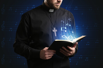 Male cantor with book on dark background