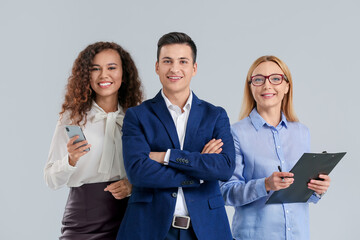 Portrait of business people on grey background