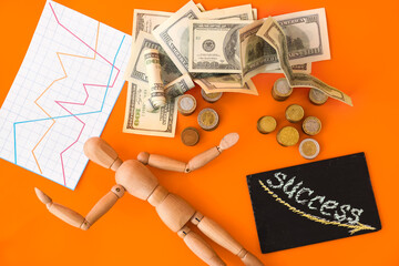 Wooden mannequin with money and word SUCCESS on color background