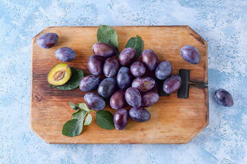 Tasty sweet plums on color background