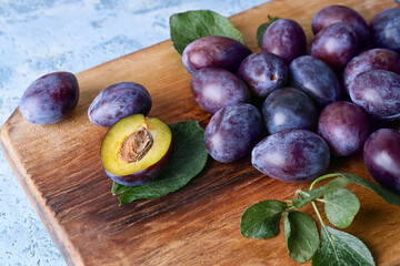 Tasty sweet plums on color background