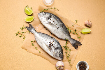Raw dorado fish with spices on color background