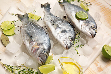 Raw dorado fish with ingredients on wooden background