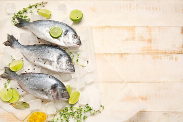 Raw dorado fish with ingredients on wooden background