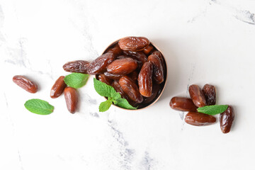 Box with sweet dates on light background