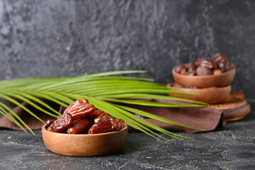 Plates with sweet dates on dark background