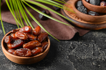 Plates with sweet dates on dark background