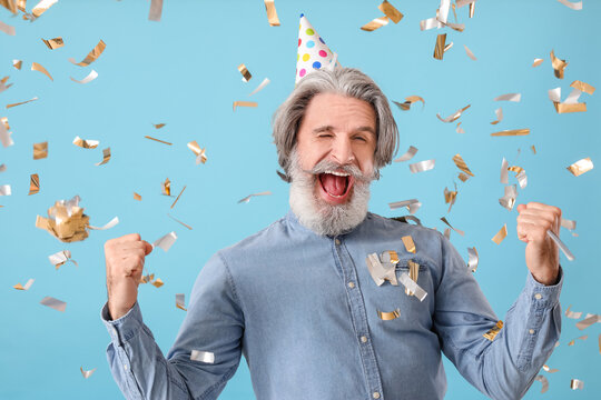 Mature Man Celebrating Birthday On Color Background