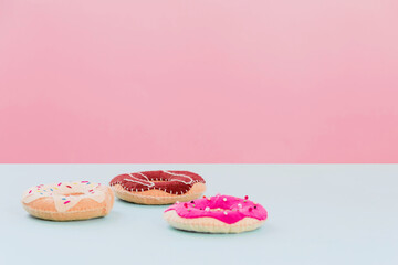 Handmade felt doughnutsare on a pink background with. Fake bakery, craft concept, diet joke right breakfast. Copy space.