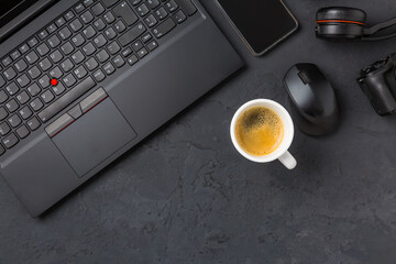 Working place and office desk with coffee, laptop, headset and smarthpone