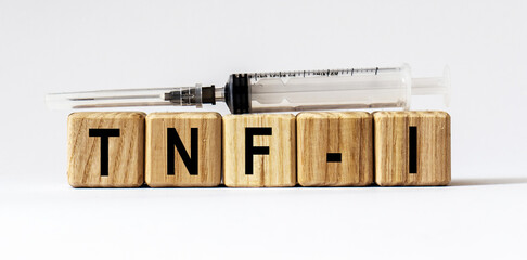 Text TNF-I made from wooden cubes. White background