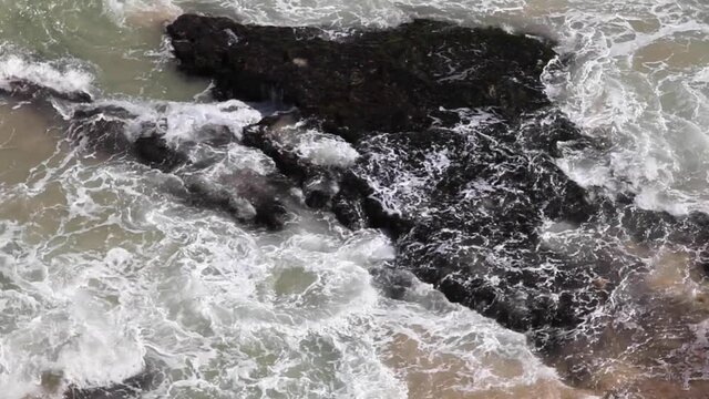 Waves crushing against rocks in Bali coast