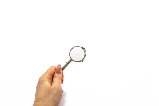 Hand hold an old vintage lorgnette from the middle of the nineteenth century on the white background