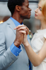 An interracial lover holding hands. Hands close-up. African man and white woman