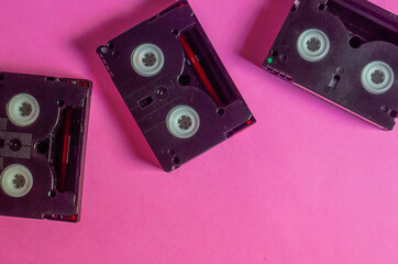 Vintage mini DV cassette tapes on pink background