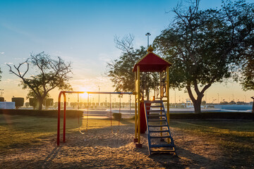 Recreation child play in King FAHAD park at Dammam Saudi Arabia with sunrise background.