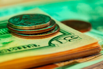 American dollar banknotes and coins on black background