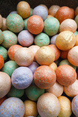 Multicolored make-up powder balls background close up