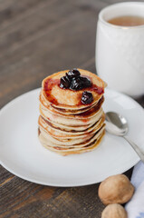 Delicious pancakes with cherry jam, soft focus.