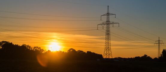 Beautiful sunset with overland high voltage lines near Tabertshausen, Bavaria, Germany
