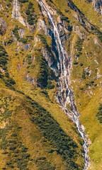 Beautiful alpine summer view with a waterfall at the famous Kaprun high mountain reservoirs, Salzburg, Austria