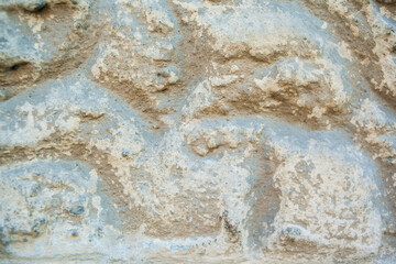 close up of old grunge painted wall with waves on it. Interior background. Stone surface. 