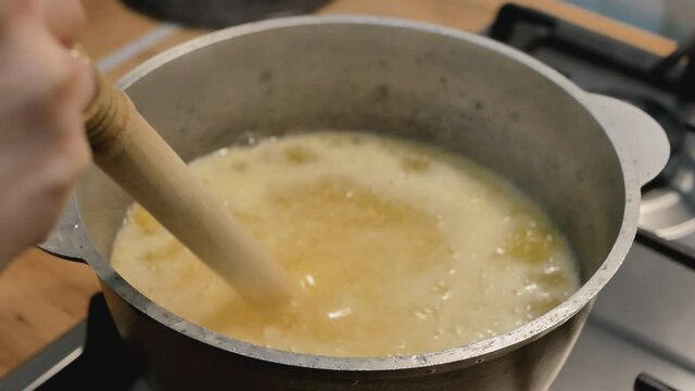 corn porridge boils on a stove. hutsul traditional dish. dietic meals