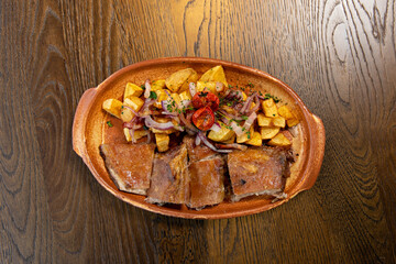 Roasted lamb meat served with fried potato