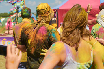 Obraz na płótnie Canvas people at the holi paint festival in clothes that were pelted with powder colored paint. hair and body are also completely covered with paints