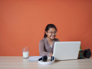 Little girl studying with laptop