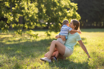 Playful kid enjoying in park with mother