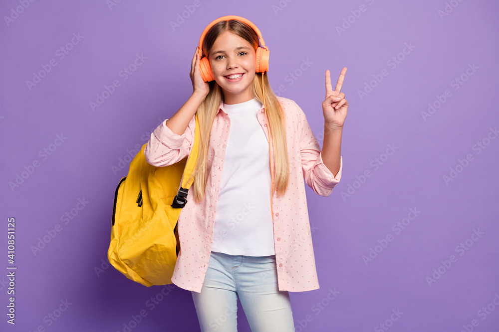 Sticker Photo of optimistic long hairdo pretty girl show v-sign wear rucksack headphones pink shirt isolated on violet color background