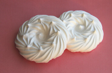 delicious italian dessert white meringues on a pink background