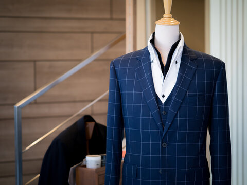 Close up of blue jacket blazer suit with black vest white shirt on mannequin detail