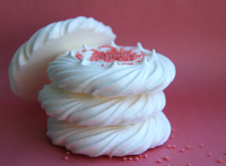 delicious italian dessert white meringues on a pink background
