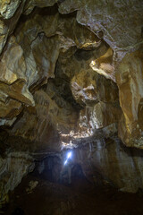 man alone caving deep in the stalactites cave