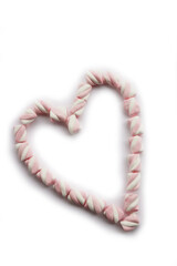 Heart made of white and pink marshmallows isolated on a plate on white background