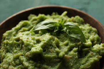 Bowl with guacamole and basil, close up